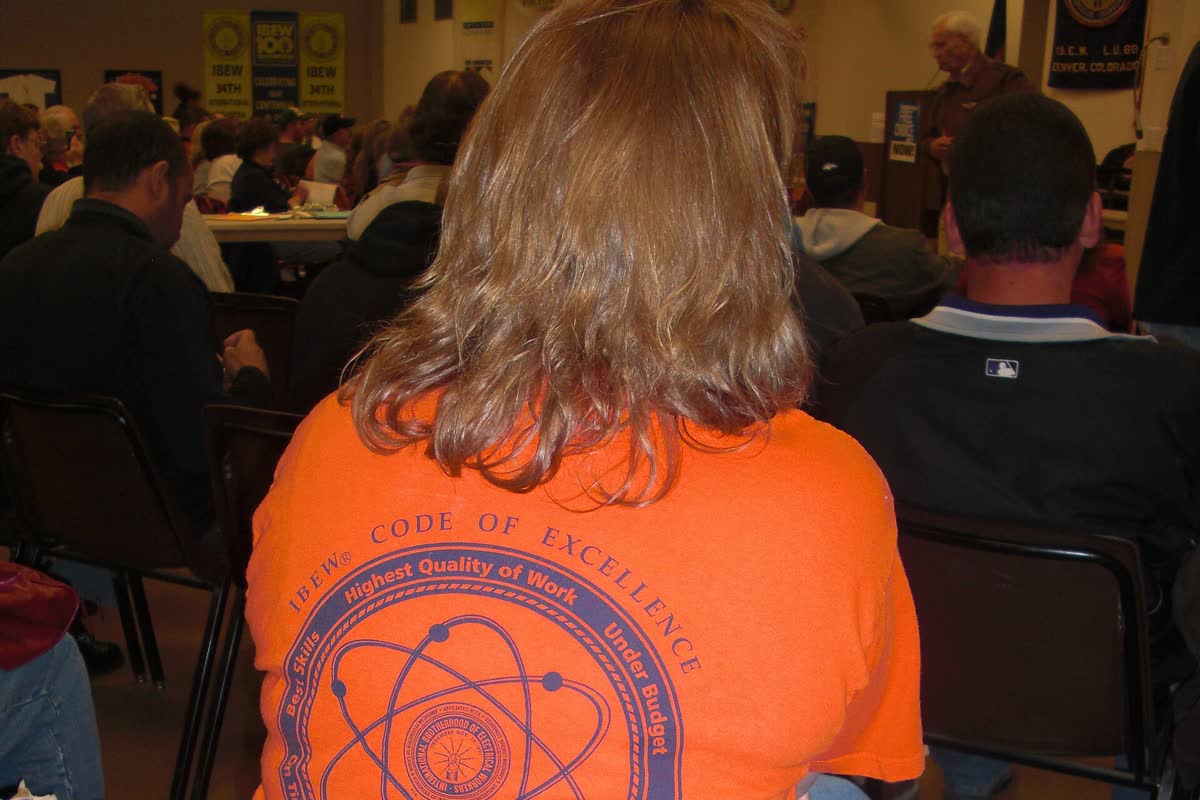 A union member standing to speak at a town hall meeting